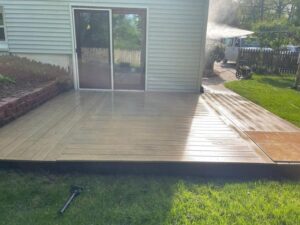 Power washing Uxbridge – Wooden deck freshly cleaned, showing bright surface and contrast from previous dirt buildup.