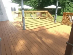 Large deck transformation featuring new flooring and railings.