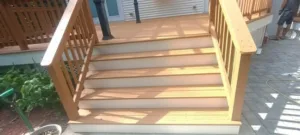 Stairs and railings after deck transformation with updated finish.