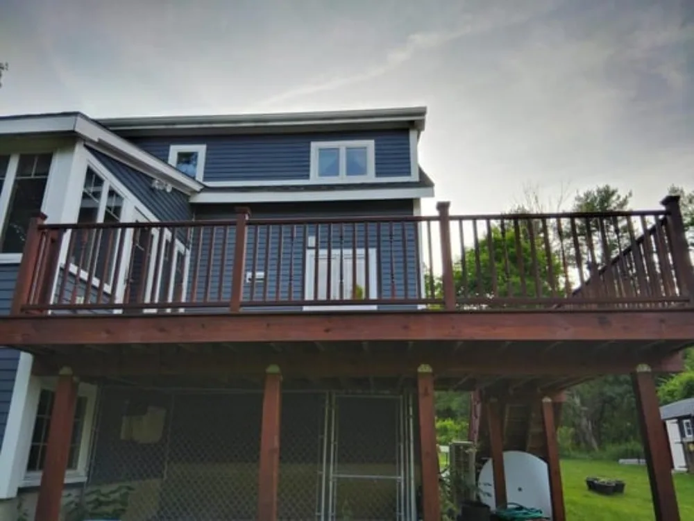 Hardwood deck restoration with elevated structure and railings.