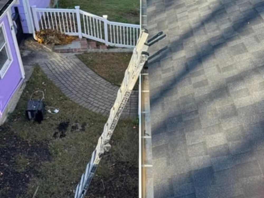 Gutter cleaning Bellingham MA with ladder positioned for safe roof access