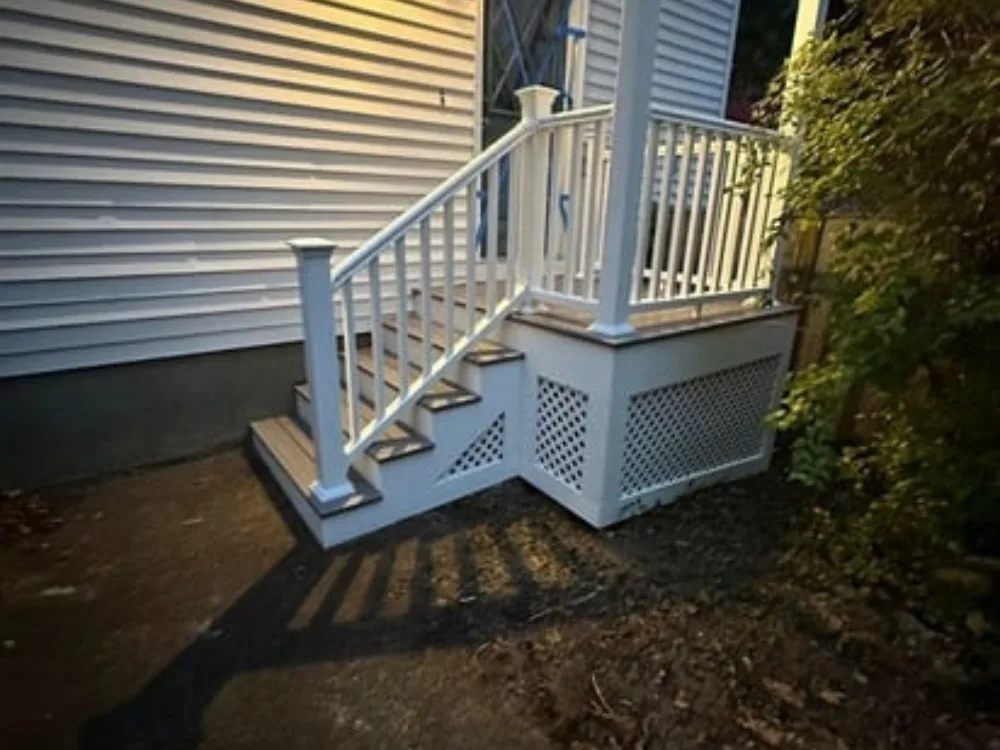 Deck Remodeling Natick MA – finished deck featuring covered roof structure and railings