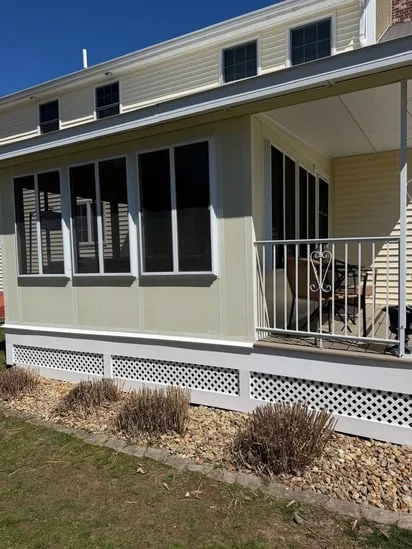 Full view of the home exterior showcasing a successful deck remodeling Milford MA.